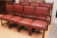 12 Henri II chairs in walnut vinyl covered