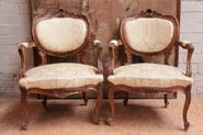 2 Louis XV arm chairs in walnut.