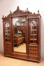 3 door gothic style armoire in walnut and beveled mirrors
