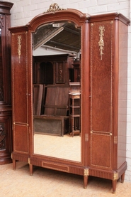 3 door Louis XVI armoire in mahogany and bronze signed MERCIER
