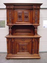 walnut cabinet with faces 19th century