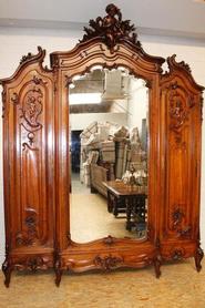 Monumental walnut 3 door Louis XV armoire with angels 19th century