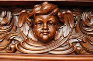 Exceptional walnut cabinet with angel faces 19th century
