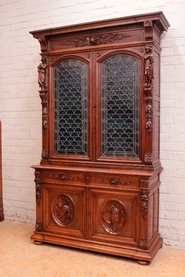exceptional figural hunt style cabinet with stain glass