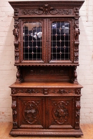 Figural hunt cabinet with stain glass