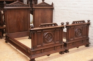 Gothic style twin beds in walnut