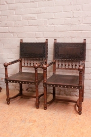 Henri II style arm chairs in oak with leather