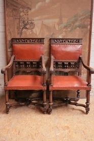 Henri II style arm chairs in walnut and leather