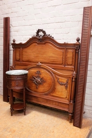 Louis XVI style bed and nightstand in mahogany