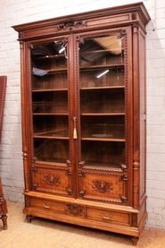 Louis XVI style bookcase in walnut and beveled glass