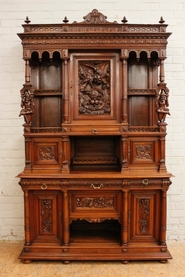 Monumental walnut Henri II jester cabinet