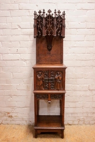 Narrow figural gothic cabinet in oak