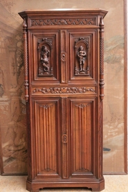 narrow figural gothic style cabinet signed by the maker
