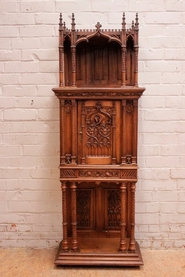 Narrow gothic-style cabinet in walnut