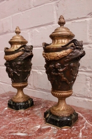 Pair bronze cherub urns on marble base