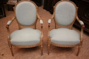 Pair Louis XVI gilt arm chairs.