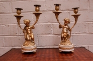 Pair putti candle sticks in gilt bronze and marble