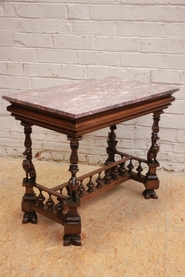 Renaissance style center table in walnut with marble top