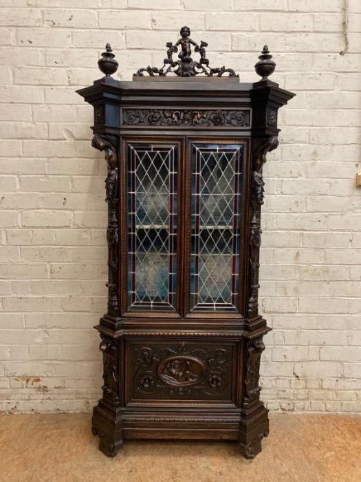 Figural renaissance cabinet in walnut with stain glass