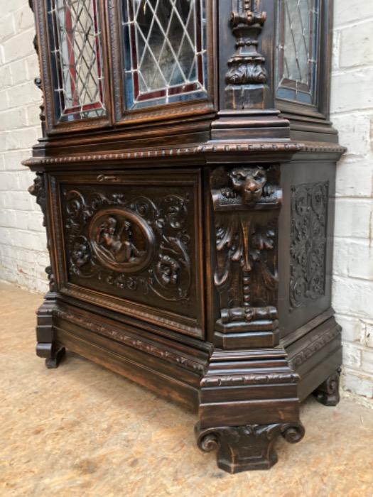Figural renaissance cabinet in walnut with stain glass