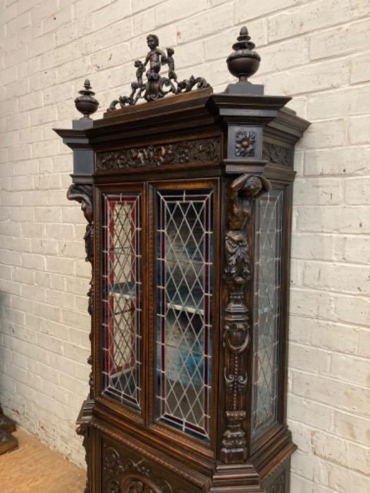 Figural renaissance cabinet in walnut with stain glass