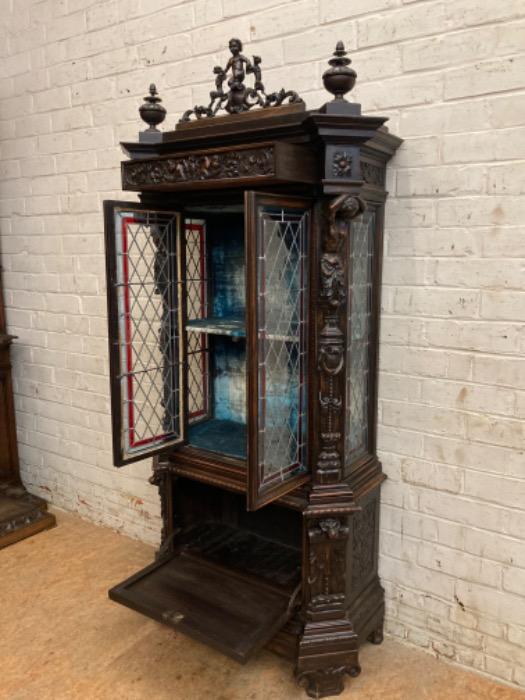 Figural renaissance cabinet in walnut with stain glass