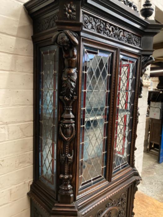 Figural renaissance cabinet in walnut with stain glass