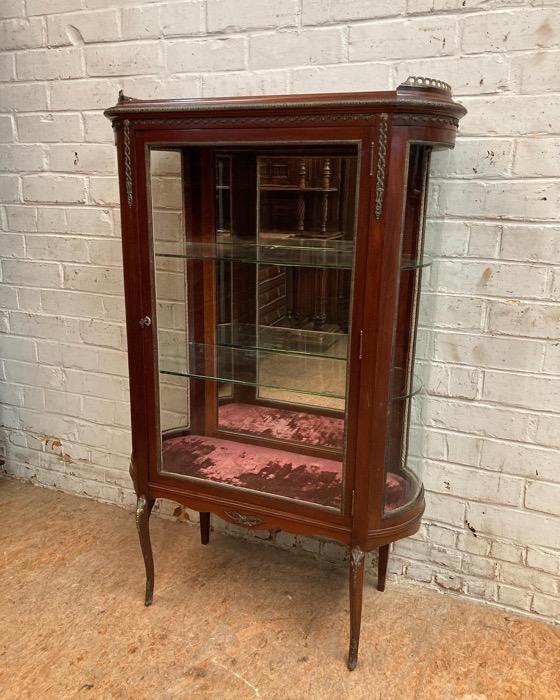 Oval display cabinet with bronze