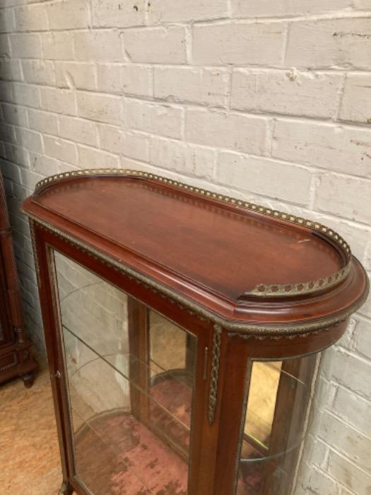 Oval display cabinet with bronze