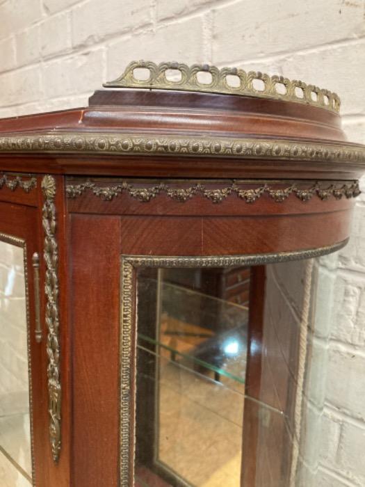 Oval display cabinet with bronze