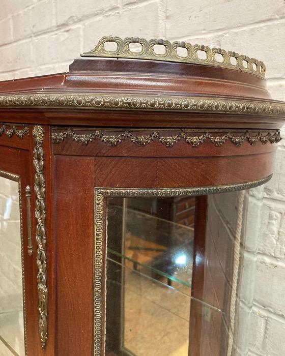 Oval display cabinet with bronze