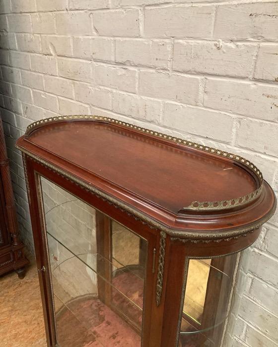 Oval display cabinet with bronze